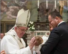  ?? (AP pool file photo/L’Osservator­e Romano) ?? Pope Francis performs a baptism at the Vatican in 2016. For the sacrament to be valid, the priest or deacon must use the precise language set forth by the Catholic Church; alteration­s of any sort are not allowed.