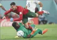  ?? (AFP) ?? Portugal’s forward Cristiano Ronaldo collides with Ghana’s goalkeeper Lawrence Ati Zigi during the Qatar 2022 World Cup Group H football match between Portugal and Ghana at Stadium 974 recently.