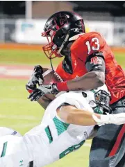  ?? [PHOTO BY STEVE SISNEY, THE OKLAHOMAN] ?? Del City’s Isaac Beverly catches a pass in the second period for a first down as he is tackled by Jared Ashcraft. McGuinness defeated Del City, 32-23.