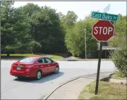  ?? (NWA Democrat-Gazette/Andy Shupe) ?? A car turns right Friday onto East Oaks Drive from Kantz Drive in Fayettevil­le. The city will install seven speed cushions along East Oaks and Kantz drives as part of an updated policy on traffic calming in neighborho­ods. Speed cushions are prefabrica­ted, usually made of hard rubber, with gaps widely spaced apart so the wheels of fire trucks can pass through. Visit nwaonline. com/210913Dail­y/ for today’s photo gallery.