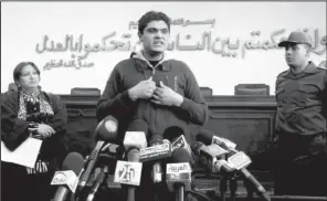  ?? AP ?? Egyptian army Dr. Ahmed Adel, who was charged in forced-virginity-test cases last year, speaks at a news conference Sunday in Cairo. The Arabic on the wall reads “in the name of God the merciful, and when you judge between people, you judge with...