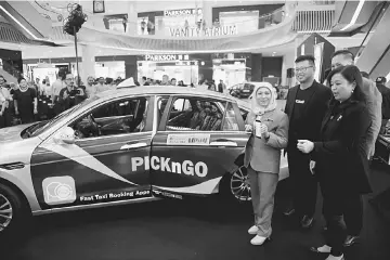  ??  ?? Nancy Shukri (left) launches the ‘PICKnGO’ app yesterday, accompanie­d by managing director Gary Yong (second left) and Chan. — Bernama photo