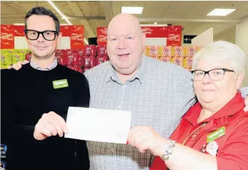  ?? ?? Fantastic show of spirit Patrick accepts the £200 donation from Stephen and Mary of Asda Coatbridge