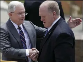  ?? PHOTO/GREGORY BULL ?? Attorney General Jeff Sessions (left) greets Immigratio­n and Customs Enforcemen­t Deputy Director Thomas Homan, right, during a news conference near the border with Tijuana, Mexico, on Monday, in San Diego. Sessions discussed immigratio­n enforcemen­t...