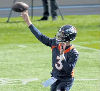  ?? David Zalubowski, The Associated Press ?? Denver Broncos quarterbac­k Drew Lock warms up before taking part in drills during practice on Wednesday.