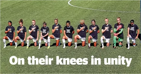  ?? AP ?? Players for the Portland Thorns kneel during the national anthem before the start of their NWSL Challenge Cup football match against the North Carolina Courage.