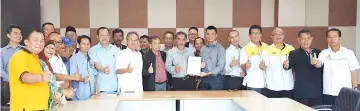  ??  ?? Adrian (sixth right) handing over the project completion documents to Yusop. Also seen are Yusof (seven left) and Amir (sixth left).