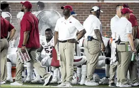  ?? NWA Democrat-Gazette/CHARLIE KAIJO ?? Turner Gill (center), Arkansas executive director of student-athlete and staff developmen­t, stands on the sidelines Saturday during the Razorbacks’ game against Ole Miss at Vaught-Hemingway Stadium in Oxford, Miss.