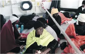  ?? — GETTY IMAGES ?? A migrant is given something to eat aboard the French NGO ship Aquarius after being rescued in the Mediterran­ean Sea.