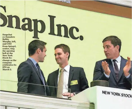 ?? AP ?? Snapchat co-founders Bobby Murphy, left, and CEO Evan Spiegel, center, ring the opening bell at the New York Stock Exchange as the company celebrates its IPO on March 2.