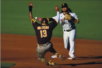  ?? JOSE CARLOS FAJARDO — BAY AREA NEWS GROUP FILE ?? The San Francisco Giants’ Brandon Crawford (35) forces out the San Diego Padres’ Manny Machado (13) at second base and throws to first for the double play in the third inning at Oracle Park in San Francisco on Sept. 25.