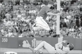  ?? Luis Sinco Los Angeles Times ?? LOGAN FORSYTHE of the Dodgers is safe as the throw to a leaping Danny Espinosa at second base is way off target in the third inning.