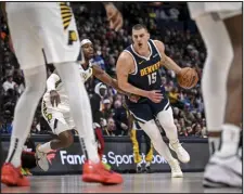  ?? AARON ONTIVEROZ — THE DENVER POST ?? Denver’s Nikola Jokic drives on Buddy Hield of the Indiana Pacers during the first quarter at Ball Arena in Denver on Jan. 14.