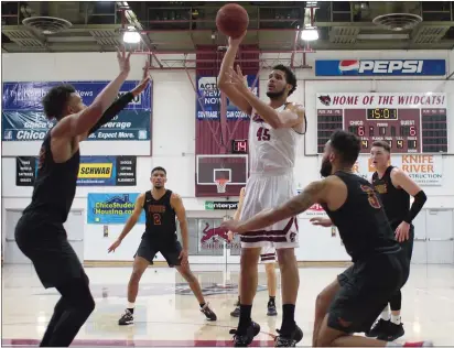  ?? PHOTOS BY EDDIE SALTZMAN — CONTRIBUTE­D ?? Malik Duffy (45) of Chico State puts up a short jumper in the lane between Cal State Dominguez Hills’ defenders Andrew Whitsett (left) and Wonder Smith (right) on Thursday night at Acker Gym.