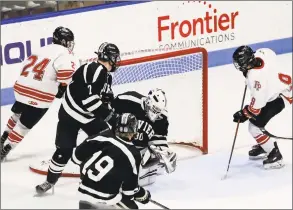  ?? John McCreary / For Hearst Connecticu­t Media ?? Fairfield Prep’s Aksel Sather (9) watches the puck cross the goal line behind Xavier goaltender Jake Wozny during their state semifinal game Wednesday in New Haven.