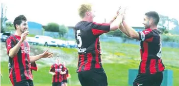  ??  ?? Celebratin­g with his Warragul United teammates, Robbie Stephen has become an important part of the defensive half for the squad since he joined in 2016.