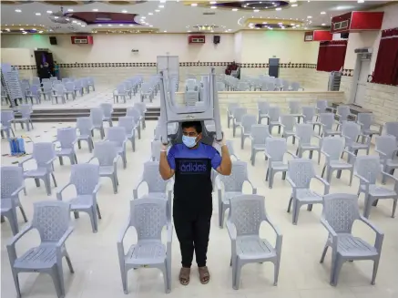  ?? (Abed Rahim Khatib/Flash90) ?? A WORKER cleans a wedding hall on June 3: ‘As the government has limited our simchas, we should as a community also do so in the post-COVID world.’