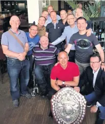  ??  ?? Celebratio­n Gordon Connelly (red top, front) and Ian Millar (extreme left) with the victorious St Modan’s team at their reunion