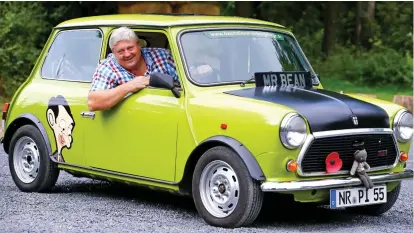  ??  ?? Driving neighbours mad: Patriotic garden display includes a ‘Mr Bean’ Mini in lime green