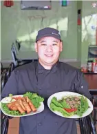  ?? PHOTOS BY ANGELA PETERSON/MILWAUKEE JOURNAL SENTINEL ?? Jackie's Café head chef Muajyeej Vang shows the restaurant's eggrolls (left) and beef laab (right).