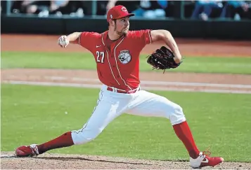  ?? ROSS D. FRANKLIN THE ASSOCIATED PRESS FILE PHOTO ?? Cincinnati Reds pitcher Trevor Bauer throws against the Los Angeles Dodgers during spring training March 2 in Goodyear, Ariz. “We’re doing irreparabl­e damage to our industry right now over rules that last AT MOST 16 months,” Bauer tweeted.