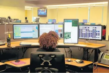  ?? STOCKER/SOUTH FLORIDA SUN SENTINEL FILE MIKE ?? Operators answer emergency calls at the Broward County 911 dispatch center at the Sunrise Public Safety Building in 2015.