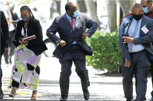  ?? Picture: Esa Alexander ?? Finance minister Tito Mboweni walks with his entourage to parliament ahead of his 2021 budget speech in the National Assembly this week.