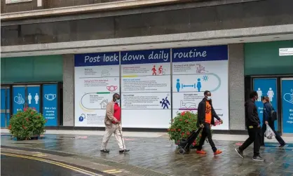  ?? Photograph: Maureen McLean/Rex/Shuttersto­ck ?? People walk past council public informatio­n signs on empty shop windows in Slough High Street, Berkshire.