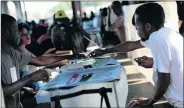  ?? Picture: REUTERS ?? CRUCIAL MOMENT: A man drops his ballot at a polling station at the Market of Canape Vert in Port-au-Prince, Haiti