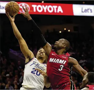  ?? GETTY IMAGES ?? Markelle Fultz of the 76ers goes up for a shot against the Heat’s Dwyane Wade during Game 2 of the teams’ first-round playoff series Monday in Philadelph­ia.