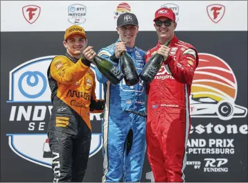  ?? MIKE CARLSON – THE ASSOCIATED PRESS ?? Josef Newgarden, center, celebrates his IndyCar win Sunday with runner-up Pato O'Ward, left, and third-place Scott McLaughlin.