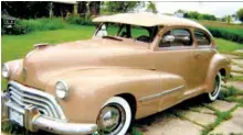  ??  ?? Russell Holt’s 1947 Oldsmobile torpedo coupe. Note cowl vent, an early form of air conditioni­ng. The 4-bar grille was employed by Olds for 1946, 1947, and all series in 1948 except for the new 98 series with new postwar “Futuramic” styling.