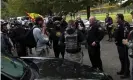  ?? Photograph: Leah Millis/Reuters ?? A police officer speaks to supporters of the Proud Boys on Saturday.