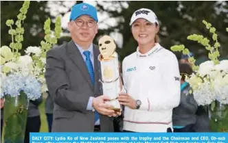  ??  ?? DALY CITY: Lydia Ko of New Zealand poses with the trophy and the Chairman and CEO, Oh-sub Kwon, after winning the Mediheal Championsh­ip at Lake Merced Golf Club on Sunday in Daly City, California. — AFP