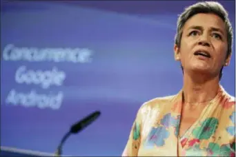  ?? OLIVIER MATTHYS — THE ASSOCIATED PRESS ?? EU Commission­er Margrethe Vestager holds a press conference on a Competitio­n Case involving Google Android at the European Commission building, in Brussels on Wednesday. he European Union’s antitrust chief has fined Google a record $5 billion for abusing the market dominance of its Android mobile phone operating system.