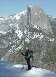  ?? AP ?? A cross-country skier in Yosemite National Park in California admires the famous Half Dome rock formation.