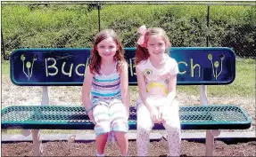  ?? Lynn Atkins/The Weekly Vista ?? Tabitha Brew and Lilianna Green test out the new Buddy Bench which was recently installed on the playground at Cooper Elementary. The first graders both know exactly how and why the bench will be used during recess next year.