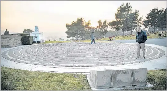  ?? Calvin B. Alagot Los Angeles Times ?? TWO PEOPLE navigate Forest Lawn Memorial Park's Labyrinth, which is modeled after the one at the Chartres Cathedral in France and is a good place to meditate.