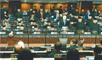  ??  ?? MPs from PAS and BN getting up from their seats moments before they left the Dewan in protest yesterday. Datuk Seri Hishammudd­in Hussein (left) and Najib exiting the Dewan.