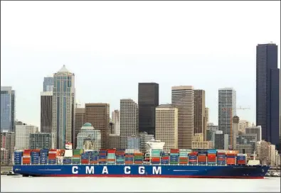  ?? AP/GENNA MARTIN ?? The container ship Benjamin Franklin is towed into Seattle’s Terminal 18 in this file photo. The U.S. trade deficit rose in January to $48.5 billion.