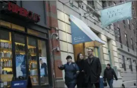  ?? PATRICK SISON — THE ASSOCIATED PRESS ?? Pedestrian­s walk past the Lucky Lee’s restaurant in the Greenwich Village neighborho­od of New York.