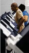  ??  ?? A man casts his ballot during early voting Saturday atthe C.T. Martin Natatorium. The primary is scheduled for May 22.