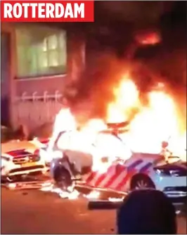  ?? ?? BLAZE: Police cars burning in the Netherland­s. Right: protests in Austria