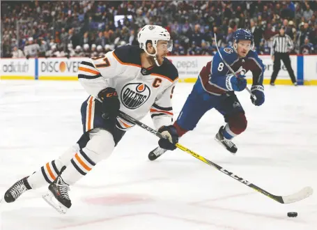  ?? HARRY HOW/GETTY IMAGES FILES ?? Connor Mcdavid of the Edmonton Oilers skates with the puck against Cale Makar of the Colorado Avalanche during NHL playoff action in June. In a Postmedia poll, several Nhlers said they'd love to have Mcdavid's speed, though Makar got a few mentions, as well.