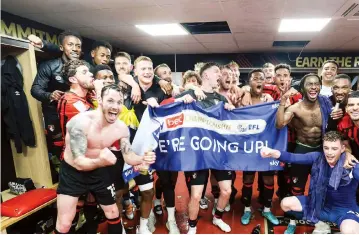  ?? ?? PROMOTION PARTY . . . Zimbabwe internatio­nal defender Jordan Zemura (holding a champagne bottle) cannot hide his excitement as he joins AFC Bournemout­h team-mates in the dressing room in celebratin­g their automatic promotion into the English Premier League football on Tuesday night