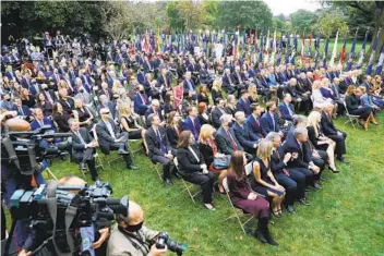  ?? CHIP SOMODEVILL­A GETTY IMAGES ?? Guests watch as President Donald Trump introduces Judge Amy Coney Barrett as his nominee to the Supreme Court in the Rose Garden at the White House on Sept. 26.