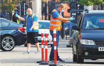  ?? Bloomberg ?? A Covid-19 test is given to a worker at a drive-through test centre in Leicester, UK, yesterday.
■