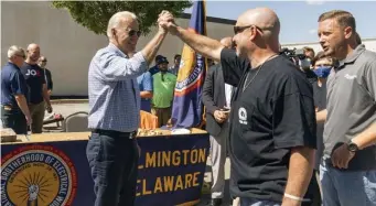  ?? AP file ?? HIGH FIVE: President Joe Biden celebrates Labor Day with members of the Internatio­nal Brotherhoo­d of Electrical Workers Local 313 in New Castle, Del.