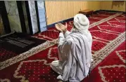  ?? RAHMAT GUL/AP ?? A Muslim prays at a mosque in Kabul, Afghanista­n, on Tuesday during the first day of the holy fasting month of Ramadan. The month is marked by lengthy prayers and daily fasting from dawn to sunset.