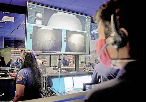  ??  ?? This Nasa photo shows members of Nasa’s Perseveran­ce Mars rover team watching in mission control as the first images arrive moments after the spacecraft successful­ly touched down on Mars at Nasa’s Jet Propulsion Laboratory in Pasadena, California.